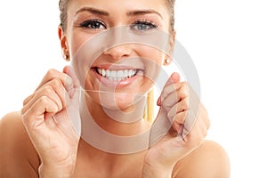 Adult woman flossing her teeth isolated on white
