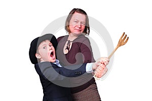 An adult woman and a funny boy dance with a kitchen fork in their han