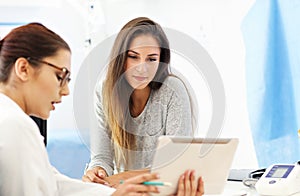 Adult woman having a visit at female doctor`s office