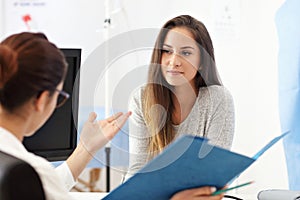 Adult woman having a visit at female doctor`s office