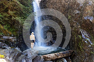 Adult Woman hiker at Norvan Falls and river stream in the natural canyon photo