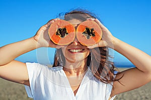 Adult woman hold in hands ripe fruit - orange papaya