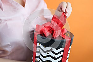 Adult woman holds box with gift, concept of love, tender relationship of couple in love, birthday, valentine`s day, mother, merry
