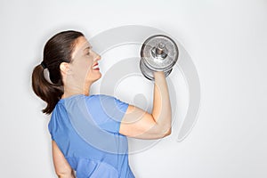 Adult woman lifting heavy dumbbell