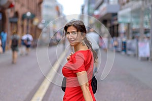 Adult woman looking over shoulder at camera