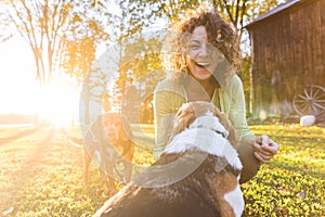 Adult woman playing with her dogs at park