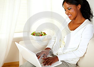 Adult woman with a pretty smile, working on laptop