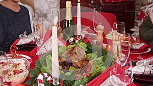 Adult woman putting down on the christmas table delicious turkey