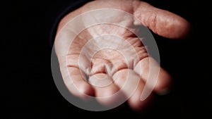 Adult woman spill on hand pills. Addiction concept. Female pours bunch of pills into the palm of her hand in a dark room