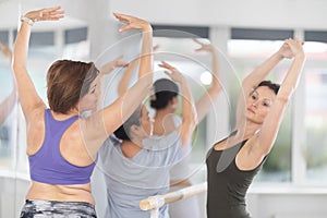 Adult woman teacher showing ballet movements