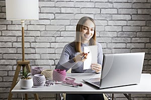 Adult woman transfering her knowledge of knitting online.