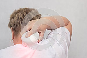 Adult woman treats the cervical spine with the help of magnetic field physiotherapy, magnetism, white background, osteochondrosis photo