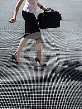 Adult woman trying to balance on high heels shoes