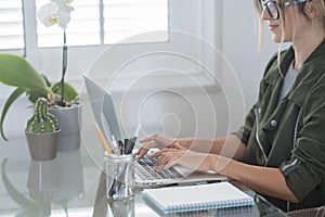 Adult woman type on laptop computer and smile happy for smart working free office home activity - modern people