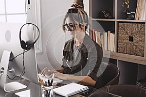 Adult woman type on laptop computer and smile happy for smart working free office home activity - modern people online job remote