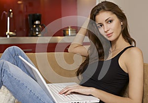 Adult woman using laptop computer at home