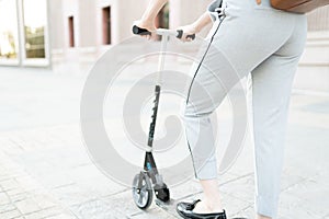 Adult woman using a scooter to get to work