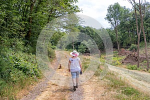 Adult woman walking with her dog on hiking trail