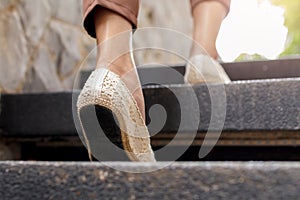 The adult woman walking up the stairs