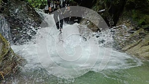 Adult Women Rappelling Huge Waterfall In Andes Rainforest