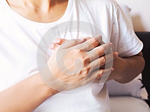 Adult women suffering from myocardial infarction, heart disease and chest pain photo