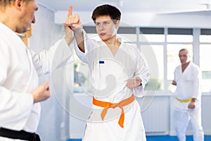 Adult and young men training karate fight