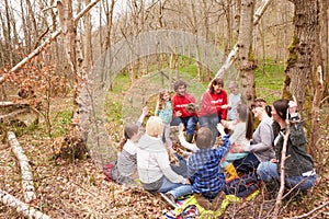 Adults And Children Examining Bird's Nest At Activity Centre