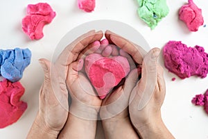 adults and children hands holding a red heart, healthcare, love, organ donation, family insurance and CSR concept,