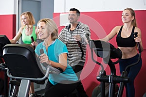 Adults in gym working out at group class