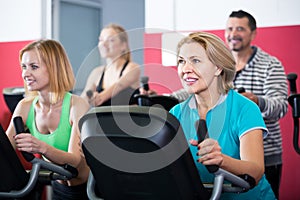 Adults in gym working out at group class