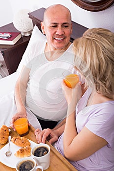 Adults posing with coffee and pastry