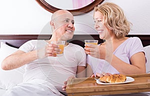 Adults posing with coffee and pastry