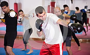 Adults training at sparring in the boxing hall