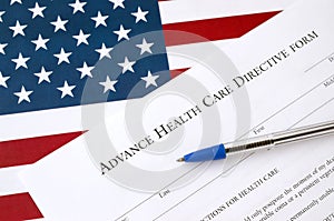 Advance health care directive blank form and blue pen on United States flag