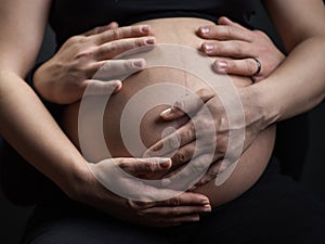 Advanced pregnancy with mom and dad's hands