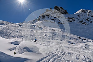 Advanced skiers exploring off piste terrain with breathtaking landscape around.