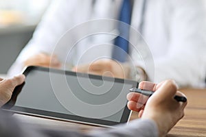 Advanced technology in the modern hospital. Patient puts an electronic signature on a health insurance contract using a