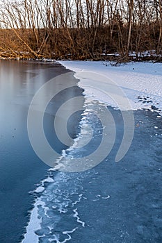 Advancing edge of a freezing lake in winter