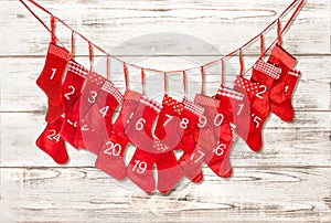 Advent calendar. Red stocking on bright wooden background