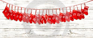 Advent calendar. Red stocking on bright wooden background