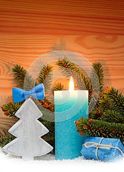 Advent candle and wood fir tree . Christmas background.