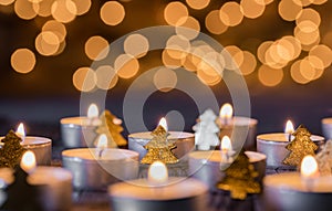 Advent and christmas background with candlelight, blurred lights and ornaments