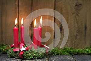 Advent or christmas wreath with four red wax candles.