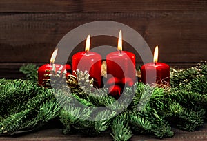 Advent decoration with four red burning candles