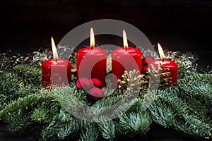 Advent decoration red burning candles christmas tree branches
