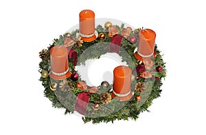 Advent wreath with cinnamon candles, golden cones and ribbon