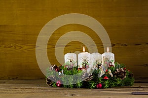 Advent wreath or crown with two burning white candles.