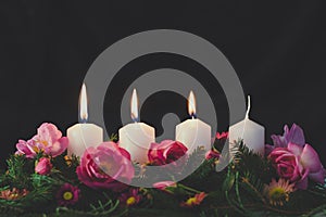 advent wreath with four candles, 3rd candle burning