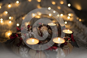 Advent wreath made from natural materials and festive closeup of burning candles