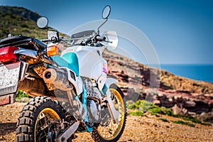 Adventure bike on a dirt road by the sea